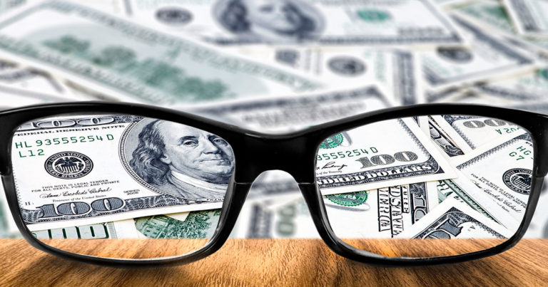 Dollar Behind Reading Glasses